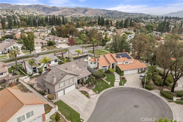 an aerial view of a house with a yard