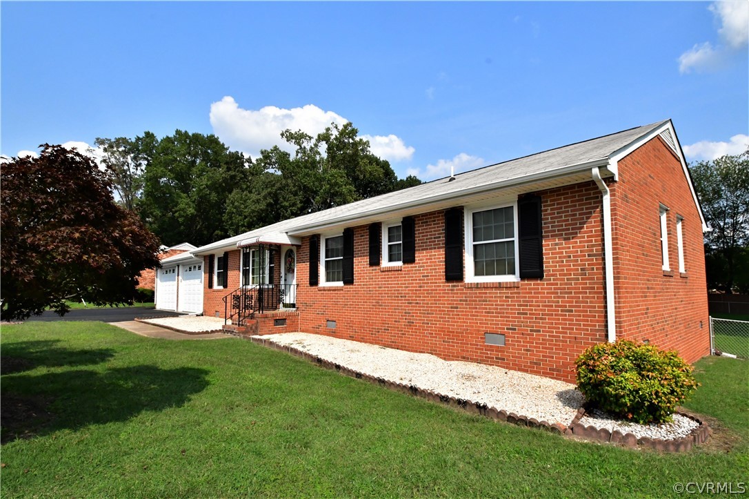 a front view of a house with a garden and yard