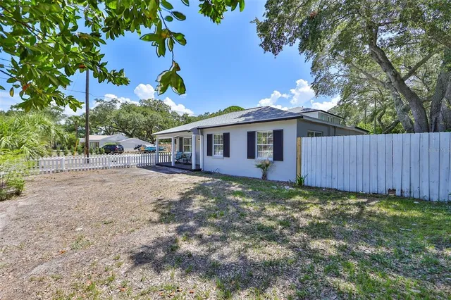 a view of an empty room and window ceiling fan