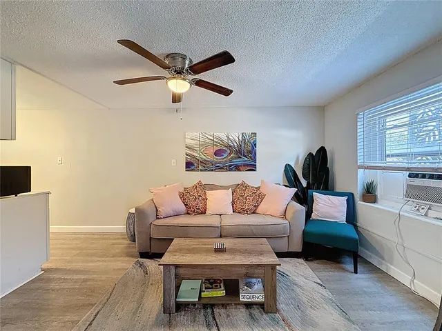 a view of a house with wooden stairs and a large tree