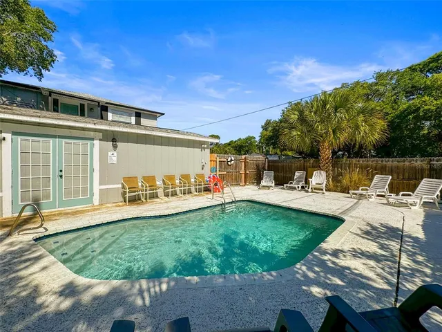 a view of a patio with table and chairs under an umbrella