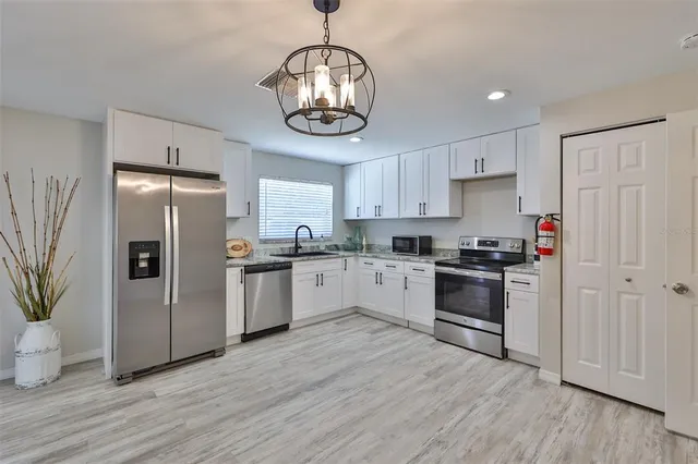 a bathroom with a toilet a sink and shower