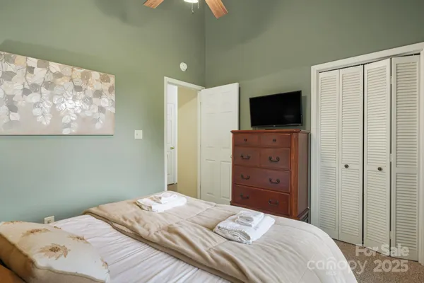 a bedroom with a bed and a television