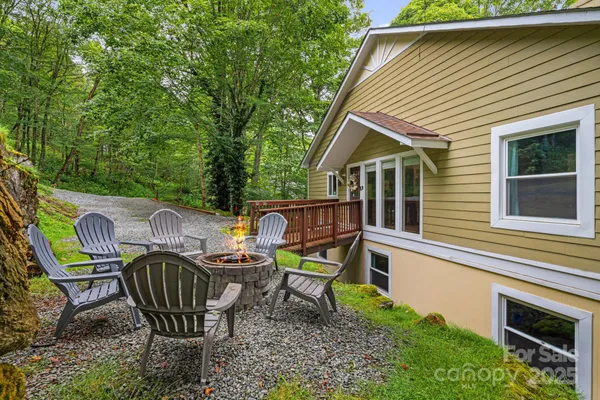 a view of a chairs and table in the back yard