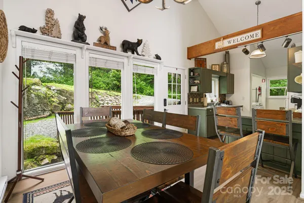 a dining room with furniture a chandelier and wooden floor
