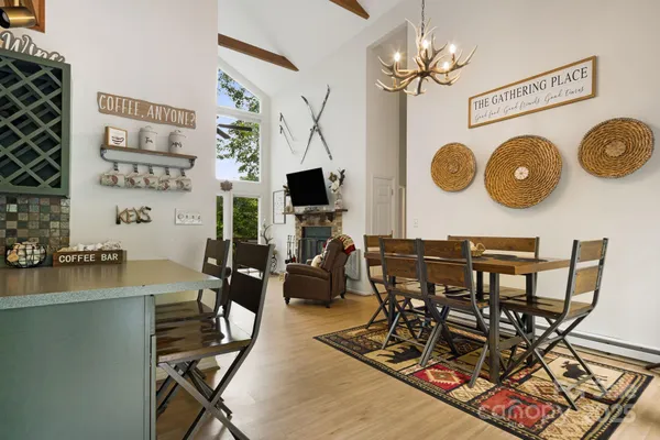 a view of a dining room with furniture and a chandelier
