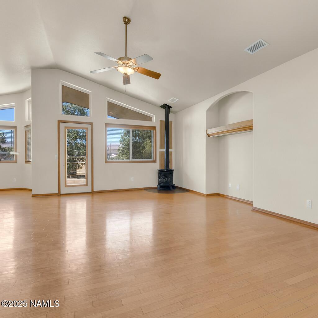 9644 North Bryant Road Flagstaff, AZ 86004 - Photo 5 of 54 a view of an empty room with a window and wooden floor