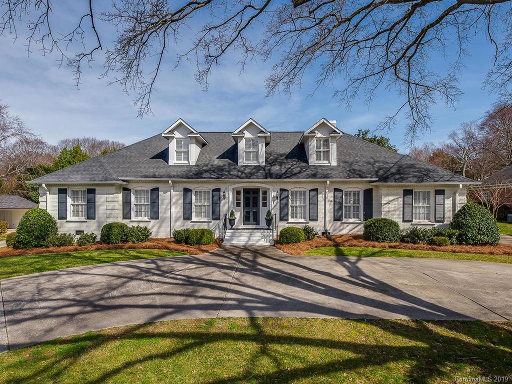 3108 Wickersham Road Charlotte, NC 28211 - Photo 1 of 34 a front view of a house with a yard table and chairs under an umbrella