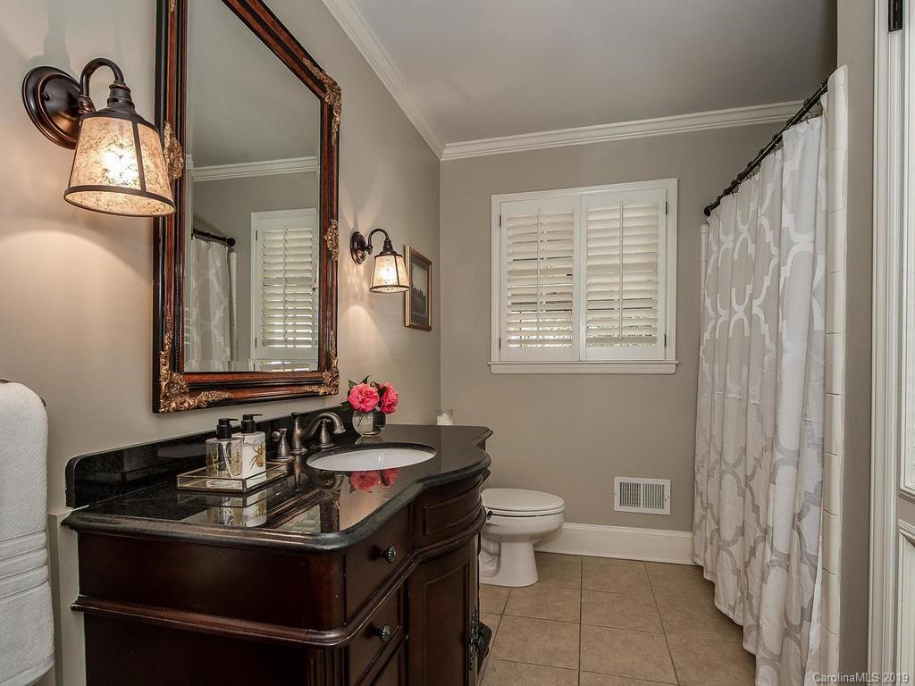 3108 Wickersham Road Charlotte, NC 28211 - Photo 14 of 34 a bathroom with a sink and a mirror