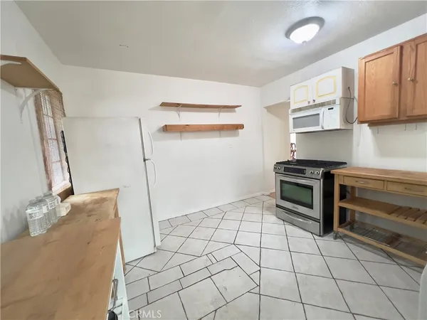 a kitchen with a stove top oven sink and cabinets
