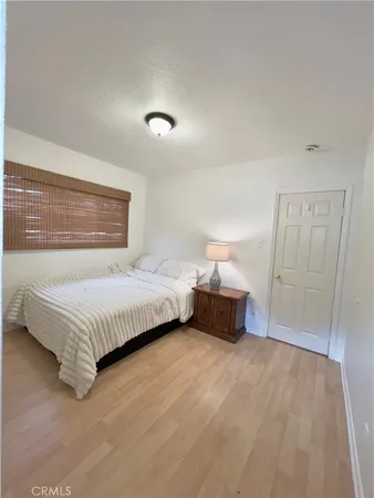 a bedroom with a bed and lamps