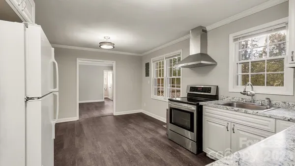 a kitchen with a stove a sink and a refrigerator
