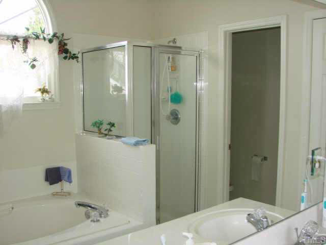2332 Bolingbrook Lane Raleigh, NC 27613 - Photo 8 of 10 The Master Bath features a nicely sized garden tub and double bathroom vanity. To finish it off is a private water closet Other