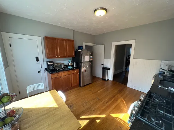 a kitchen with a stove and a refrigerator