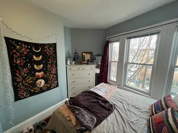 a bedroom with a bed and a window