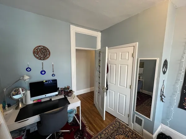 a view of a workspace with furniture and a window