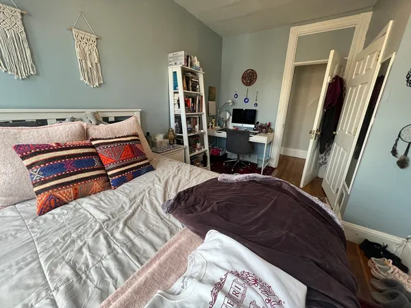 a bedroom with furniture and a window