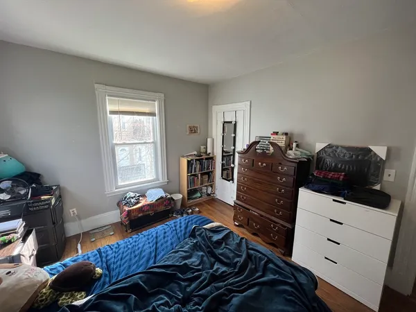 a bedroom with a bed and a window
