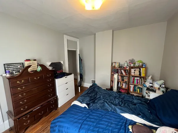 a bed room with a bed and a dresser