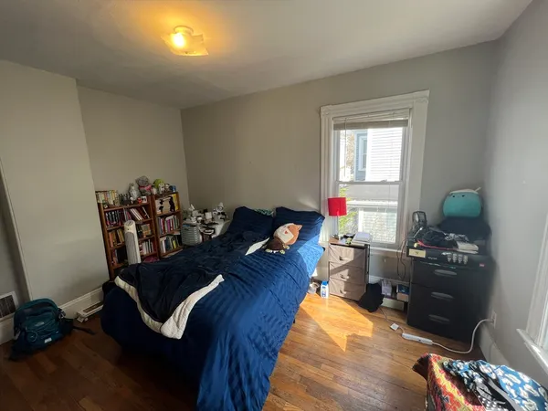 a living room with furniture fireplace and wooden floor