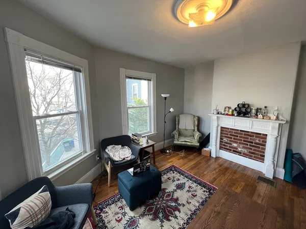 a living room with furniture fireplace and window