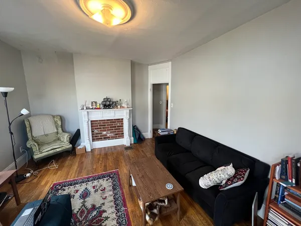 a living room with furniture and a lamp