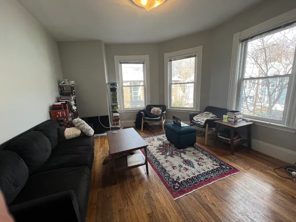 a living room with furniture rug and window