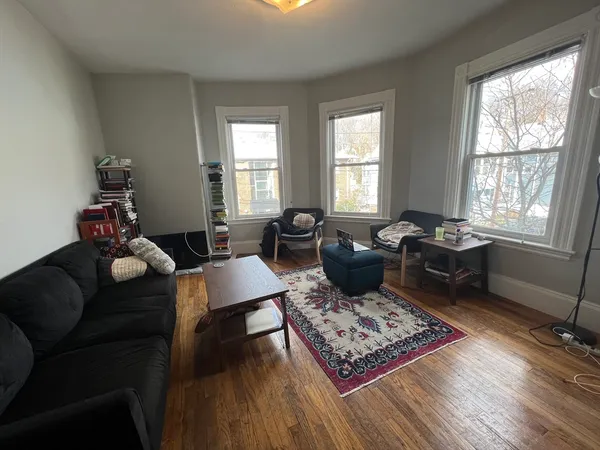 a living room with furniture rug and window