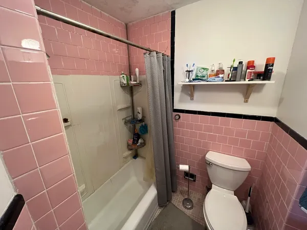 a bathroom with a toilet and a shower