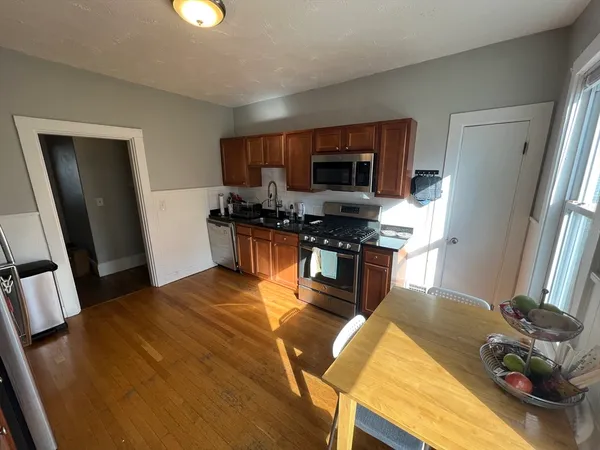 a kitchen with stainless steel appliances granite countertop a sink refrigerator and microwave