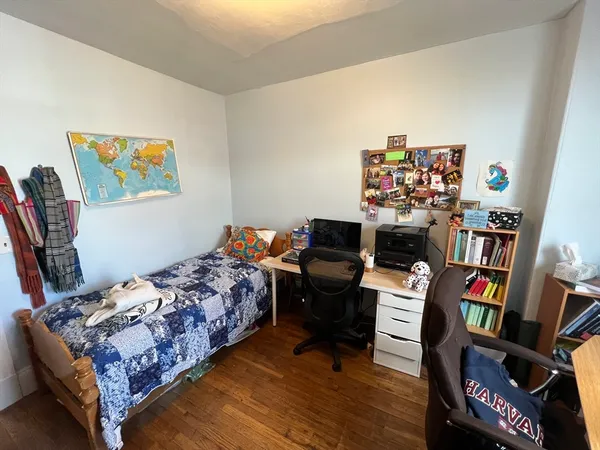 a bedroom with bed and a bookshelf