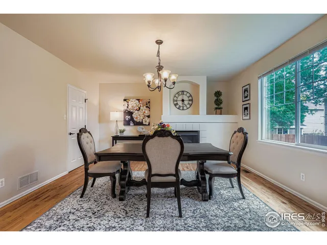 a dining room with furniture a rug and a large window