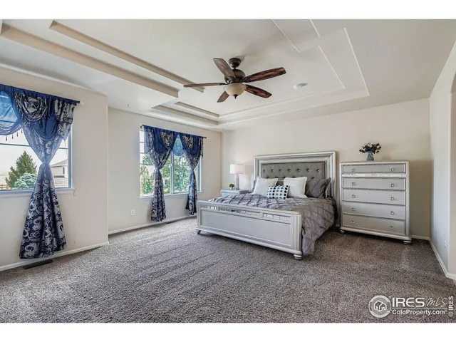 a spacious bedroom with a bed and a window