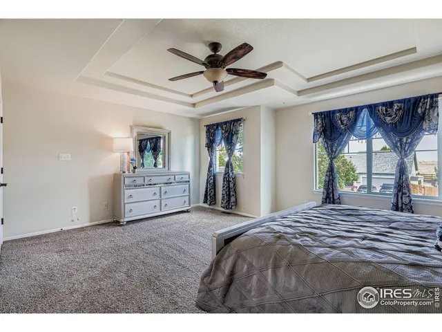 a view of a livingroom with a ceiling fan and window