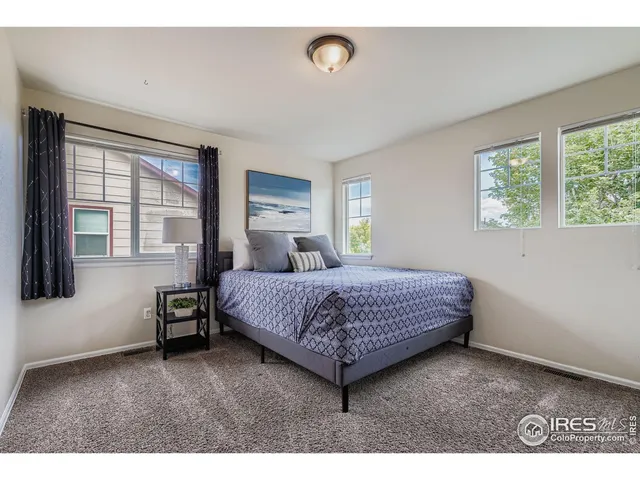 a bedroom with a bed window and a desk