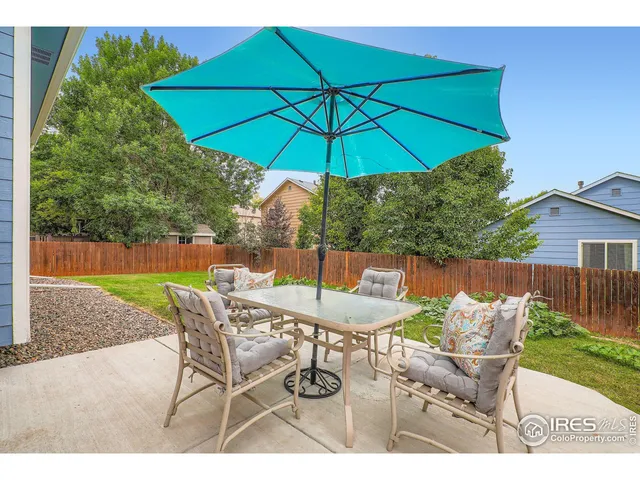 a patio with a yard table and chairs