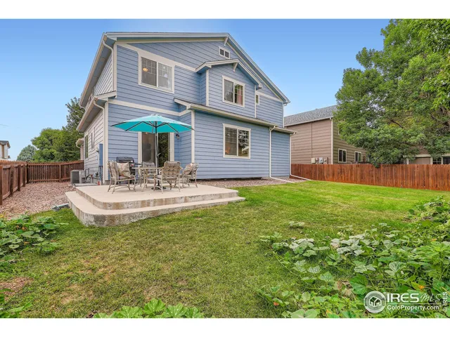 a view of a house with patio and a garden