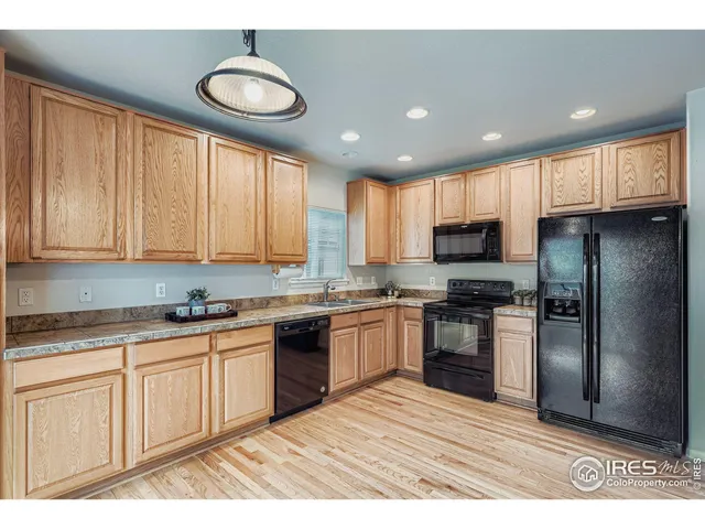 a kitchen with granite countertop stainless steel appliances and wooden cabinets