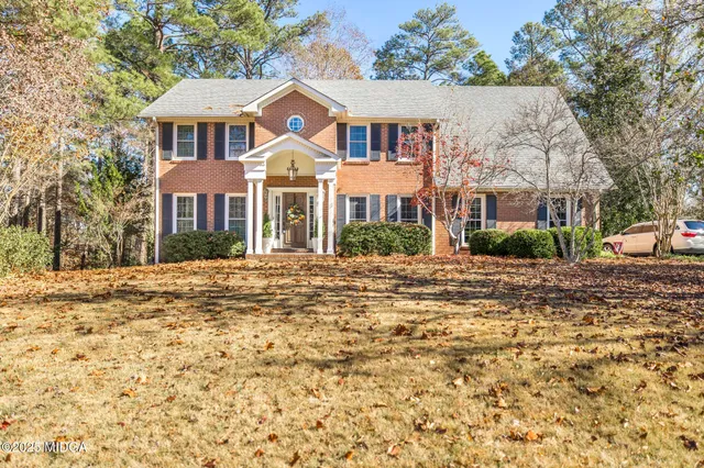 a bathroom with a sink vanity mirror and toilet