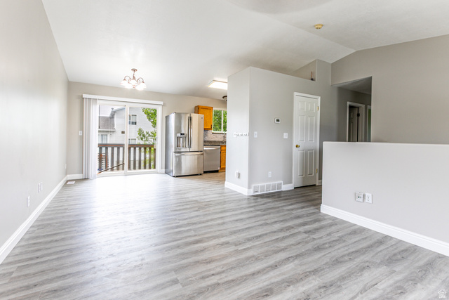 4239 West 5325th Street South Roy, UT 84067 - Photo 3 of 26 Open-concept living space with light wood-finish flooring