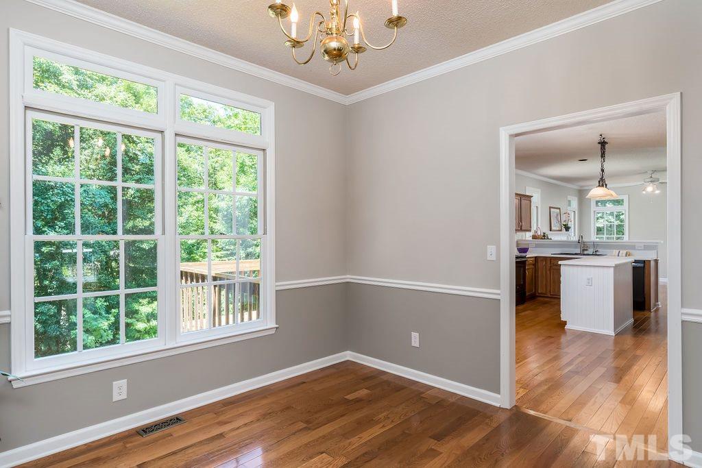 3433 Singleleaf Lane Raleigh, NC 27616 - Photo 11 of 28 wooden floor in an empty room with a window