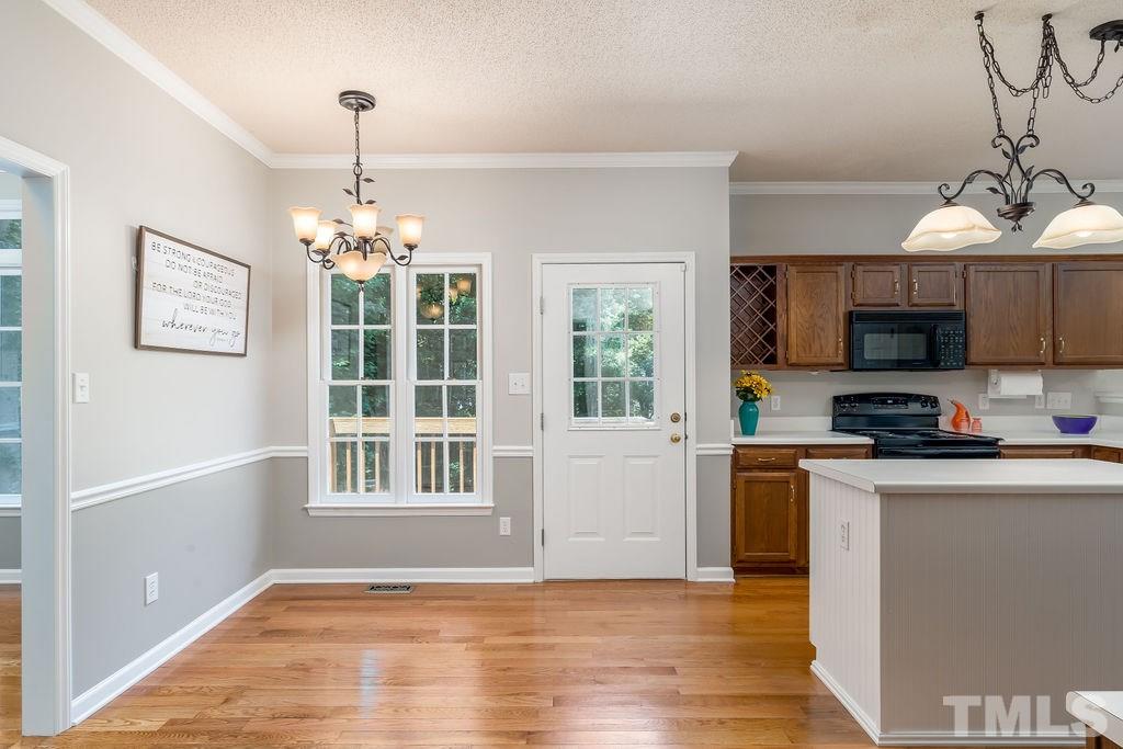 3433 Singleleaf Lane Raleigh, NC 27616 - Photo 12 of 28 a view of a kitchen with microwave and wooden floor