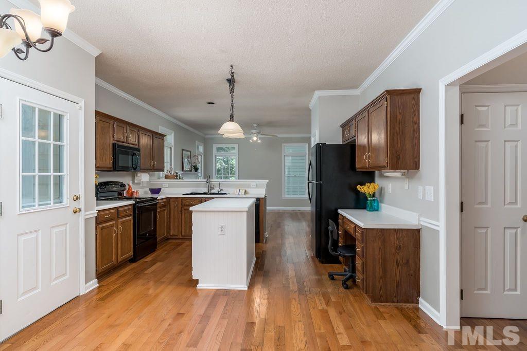 3433 Singleleaf Lane Raleigh, NC 27616 - Photo 13 of 28 a kitchen with a sink stainless steel appliances and cabinets