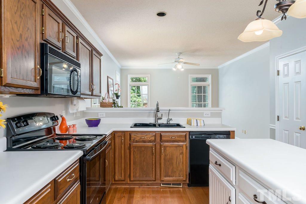 3433 Singleleaf Lane Raleigh, NC 27616 - Photo 14 of 28 a kitchen with a sink a stove and cabinets