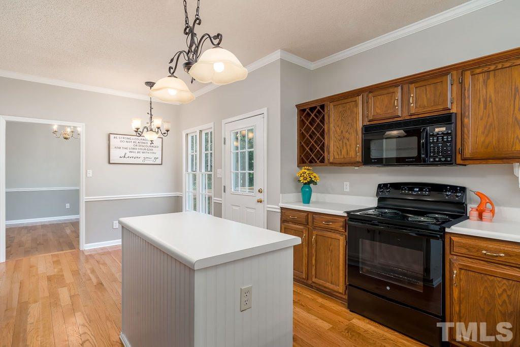 3433 Singleleaf Lane Raleigh, NC 27616 - Photo 15 of 28 a kitchen with a stove and a microwave