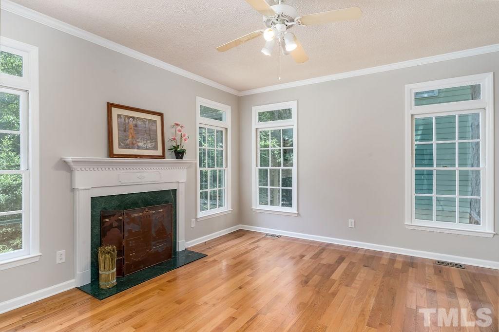 3433 Singleleaf Lane Raleigh, NC 27616 - Photo 16 of 28 a view of an empty room with windows and a fireplace