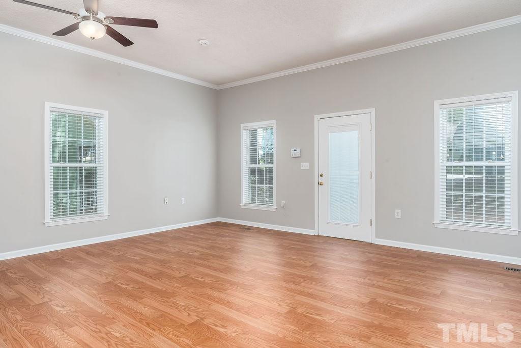 3433 Singleleaf Lane Raleigh, NC 27616 - Photo 27 of 28 a view of an empty room with a window and wooden floor