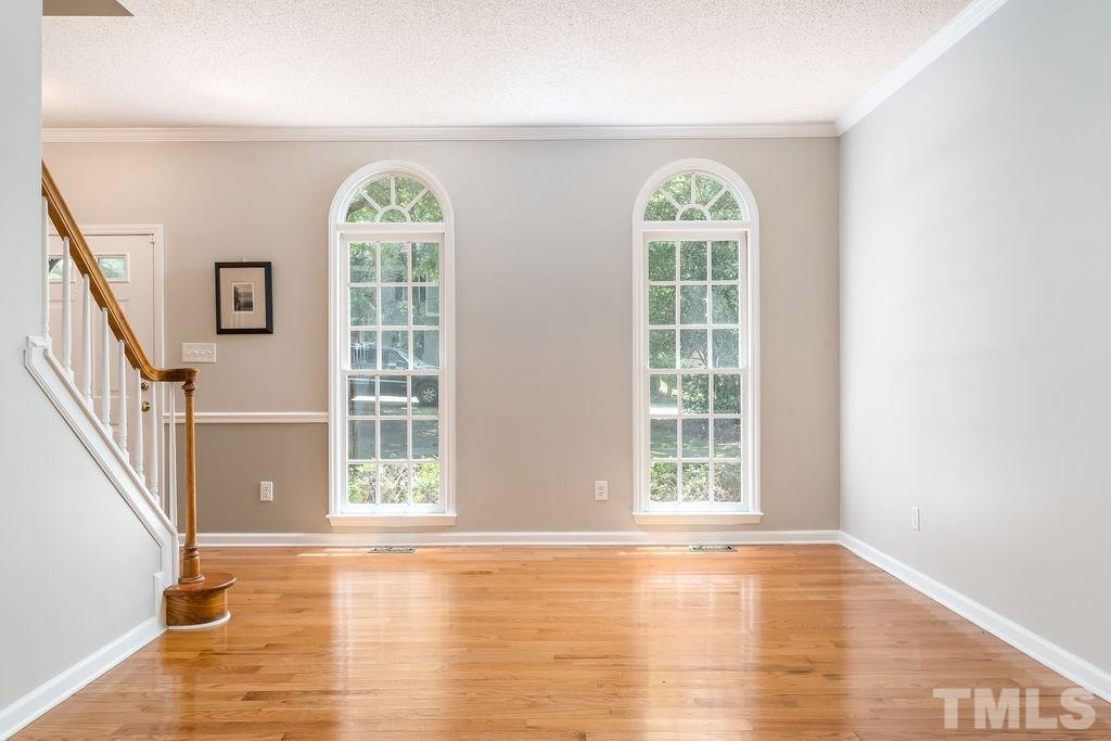 3433 Singleleaf Lane Raleigh, NC 27616 - Photo 8 of 28 a view of an empty room with wooden floor and a window