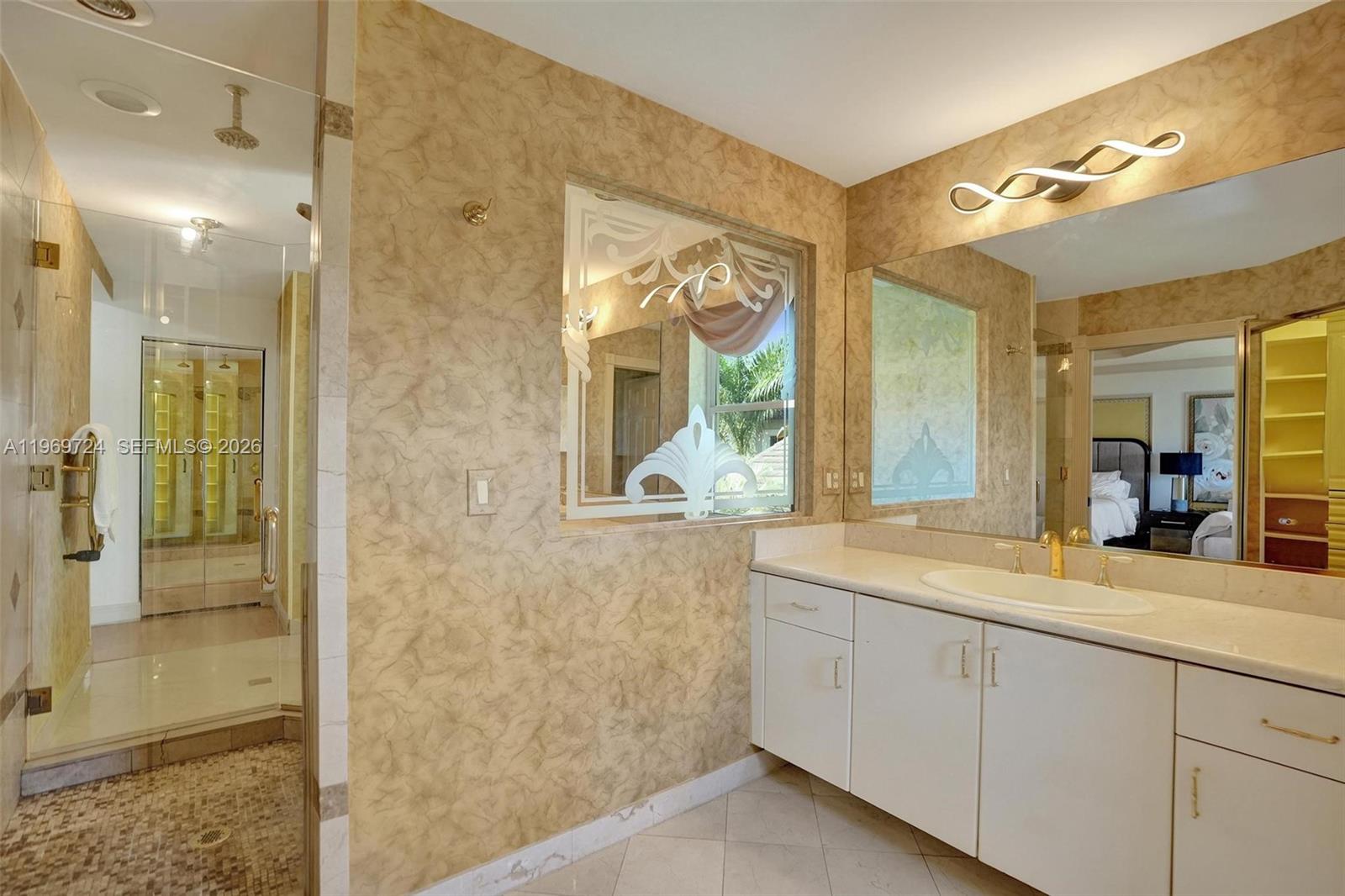 17431 Southwest 35th Street Miramar, FL 33029 - Photo 16 of 61 a spacious bathroom with a granite countertop sink mirror and shower