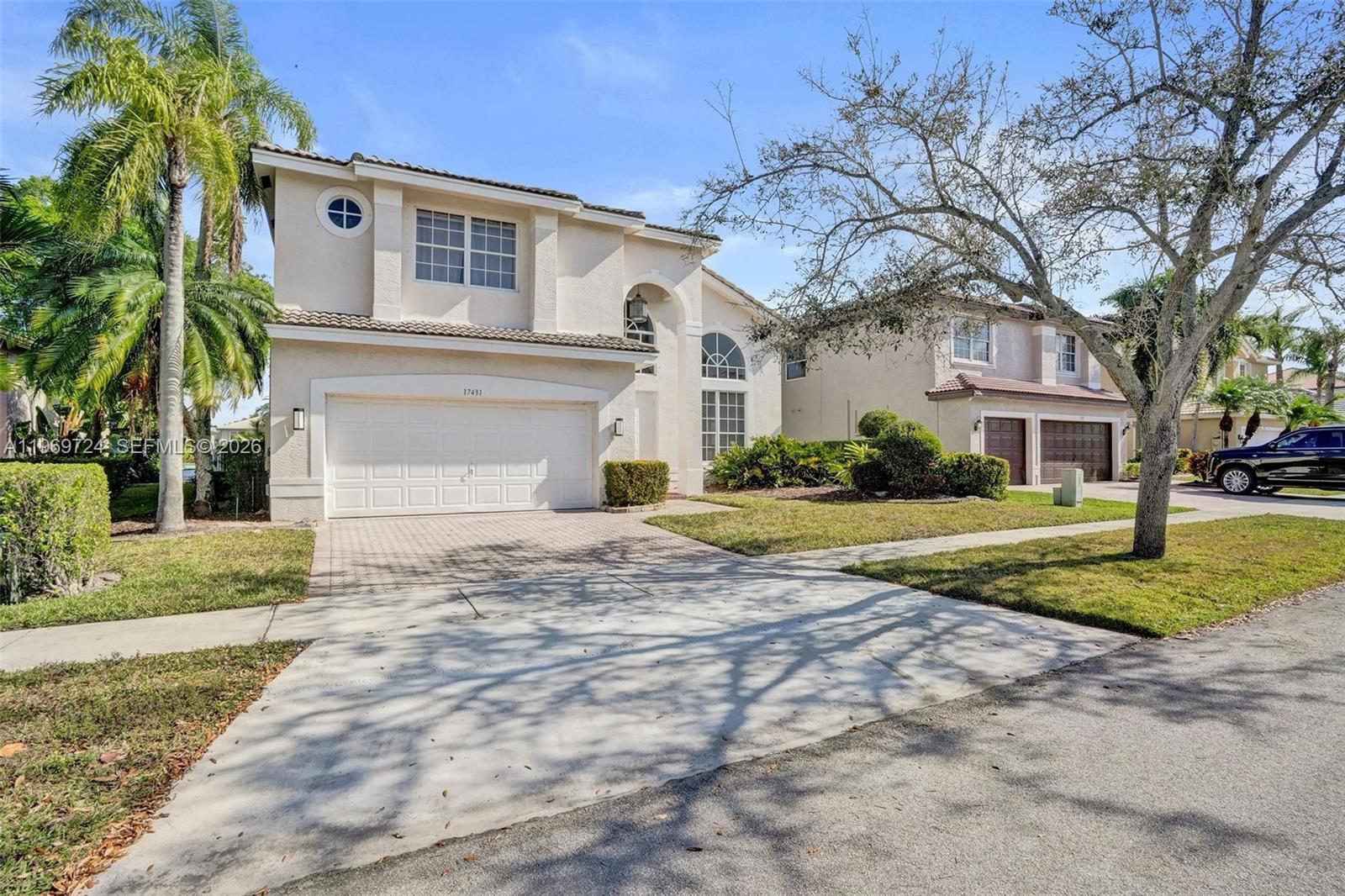 17431 Southwest 35th Street Miramar, FL 33029 - Photo 2 of 61 a front view of a house with a yard and trees